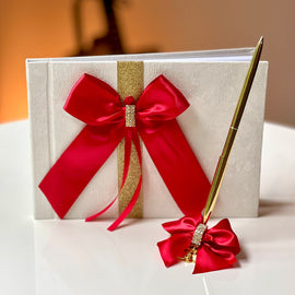 red and gold guest book with pen